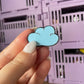 Fluffy Cloud Enamel Pin - A whimsical enamel pin featuring a cute and smiling cloud, perfect for dreamers and lovers of all things cute and uplifting.