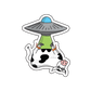 Sticker of a cow being abducted by aliens, suspended upside down with secured legs, radiating a blend of amusement and curiosity.