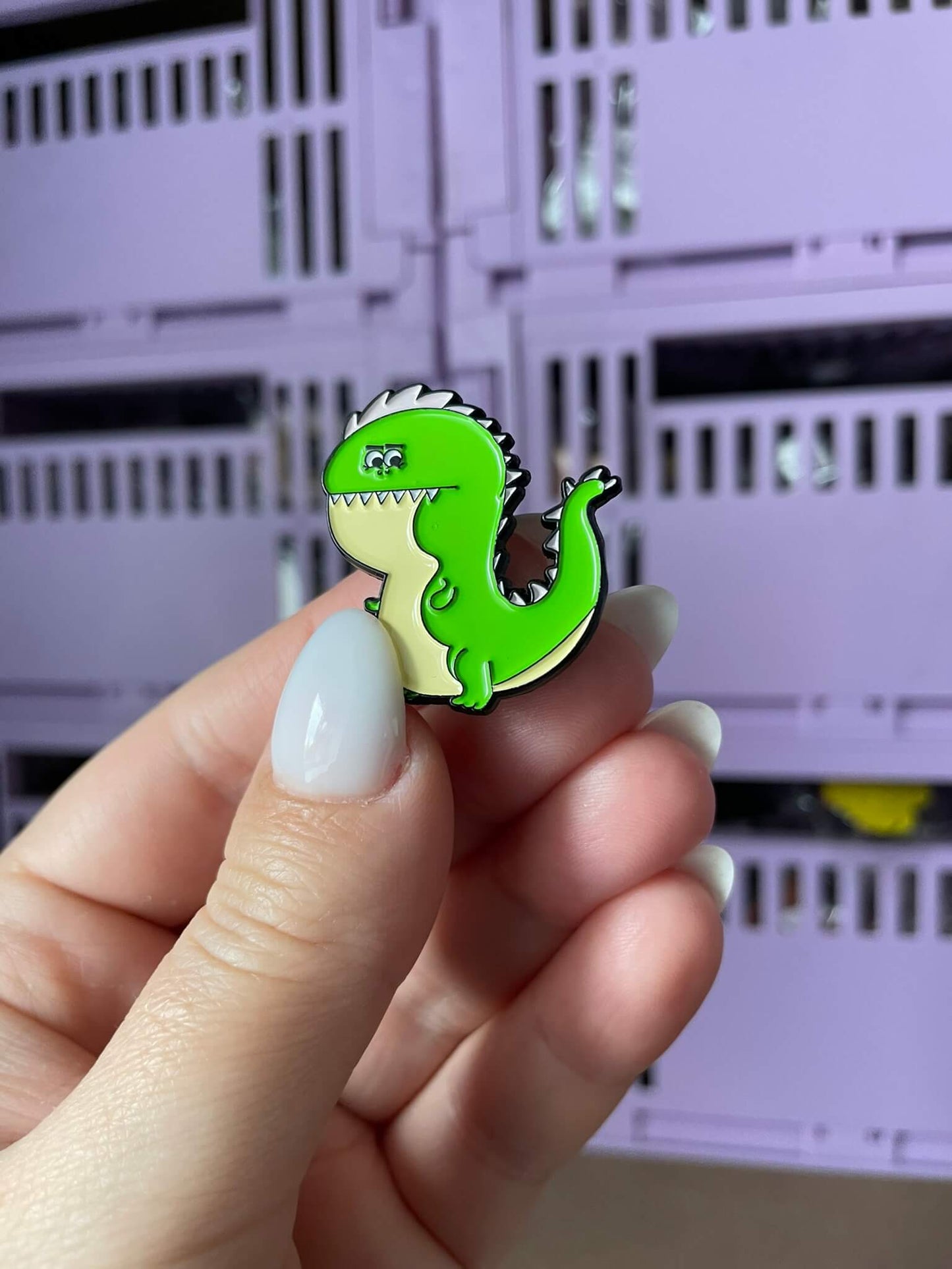 Tiny Dino Delight Enamel Pin - An adorable enamel pin featuring a baby T-Rex dinosaur, perfect for dino enthusiasts and lovers of cute accessories.