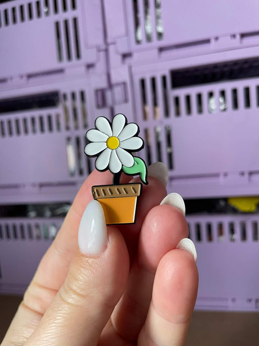 Cute Flower Enamel Pin - A vibrant and detailed enamel pin in the shape of a cute flower, perfect for adding a touch of spring to your outfits.