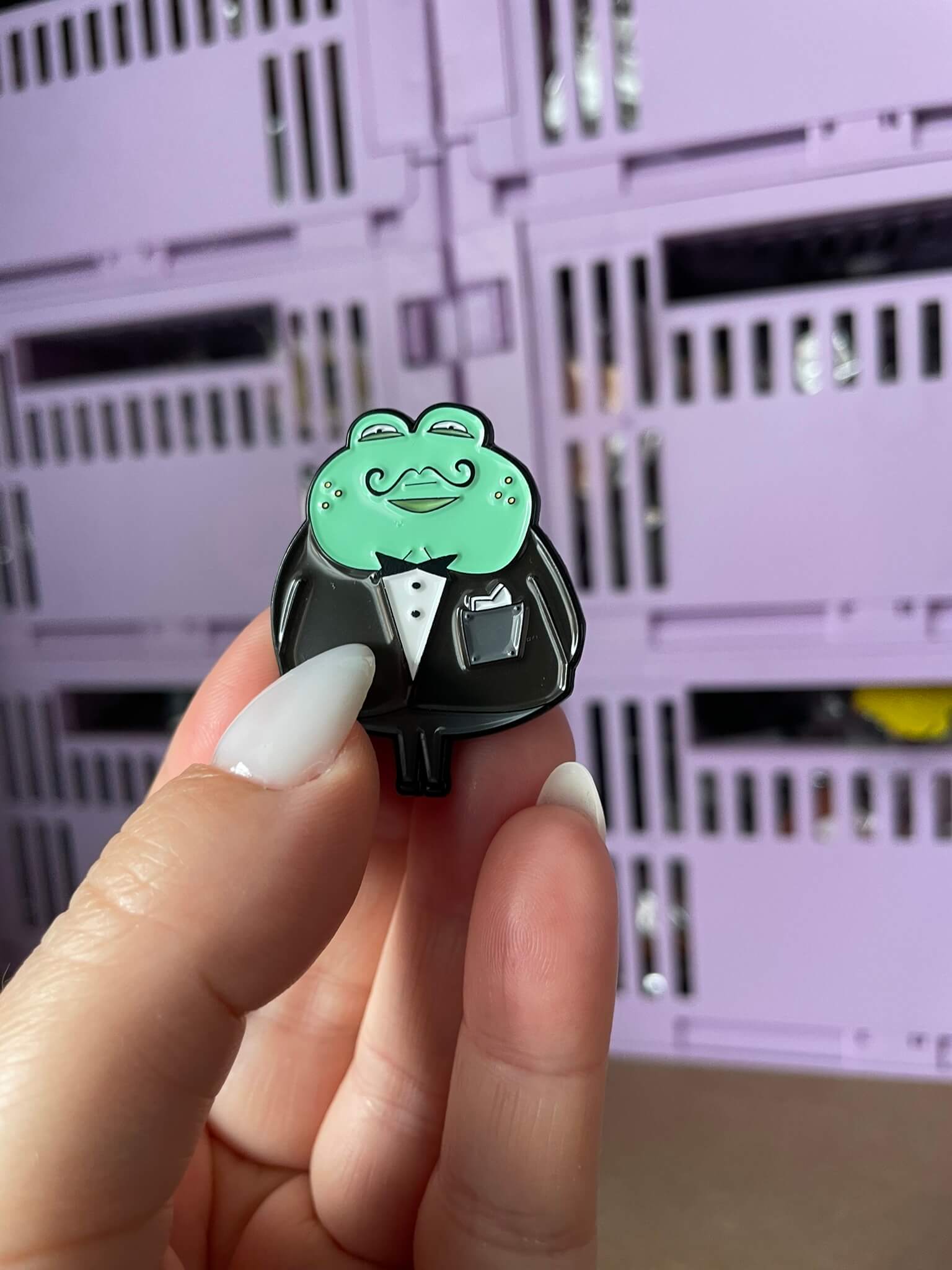 Dapper Frog Enamel Pin - A clever enamel pin featuring a smartly dressed frog in a suit and bowtie, perfect for those who appreciate wit and style in their accessories