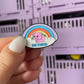 Kindness Piggy Enamel Pin - An endearing enamel pin featuring a cute piggy holding a rainbow with 'Be Kind' below, perfect for spreading positivity and promoting kindness.