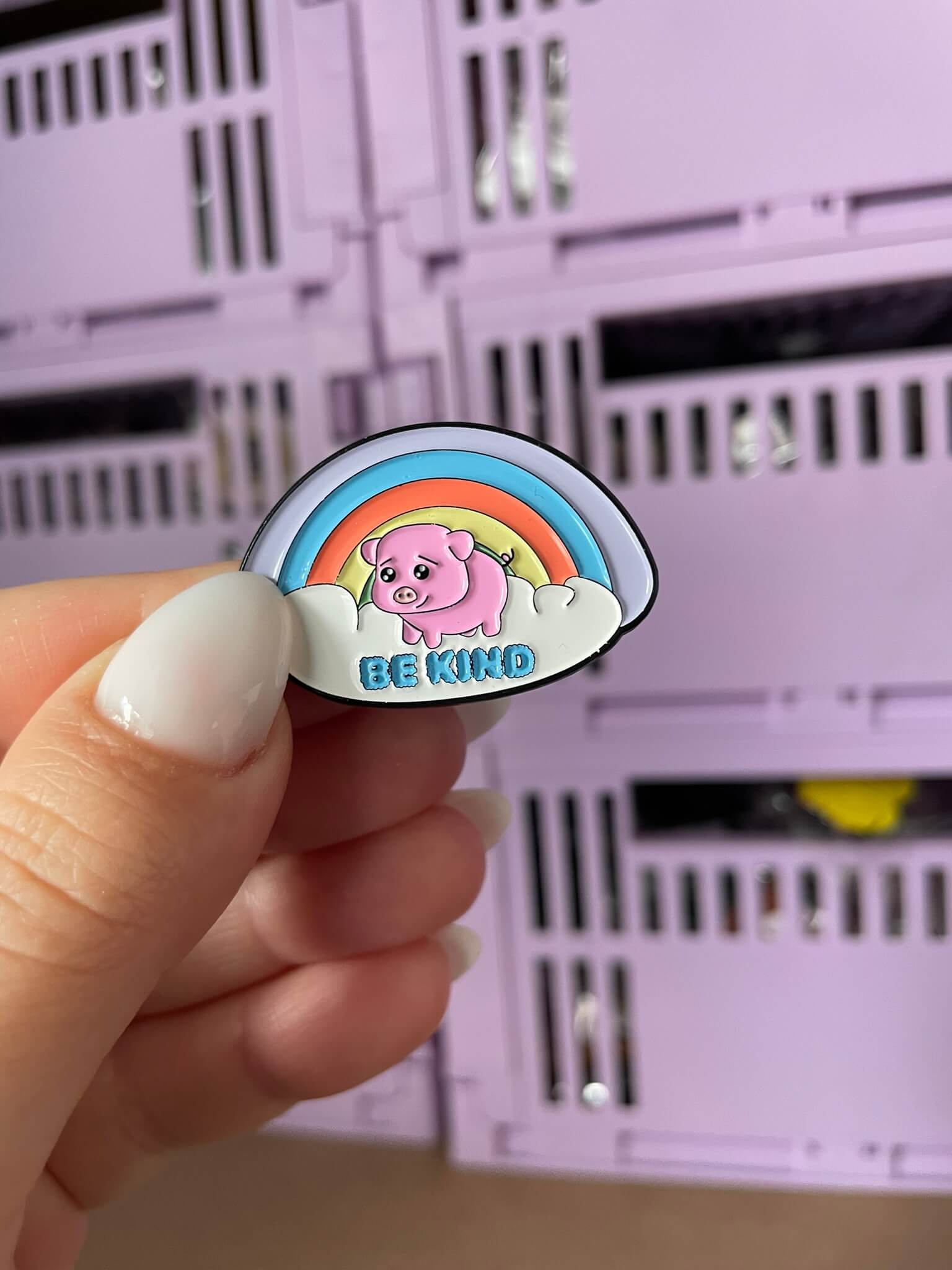 Kindness Piggy Enamel Pin - An endearing enamel pin featuring a cute piggy holding a rainbow with 'Be Kind' below, perfect for spreading positivity and promoting kindness.