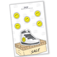 "Stylish shoes on sale, adorned with a smiley face sticker, embodying fashion and a touch of fun.